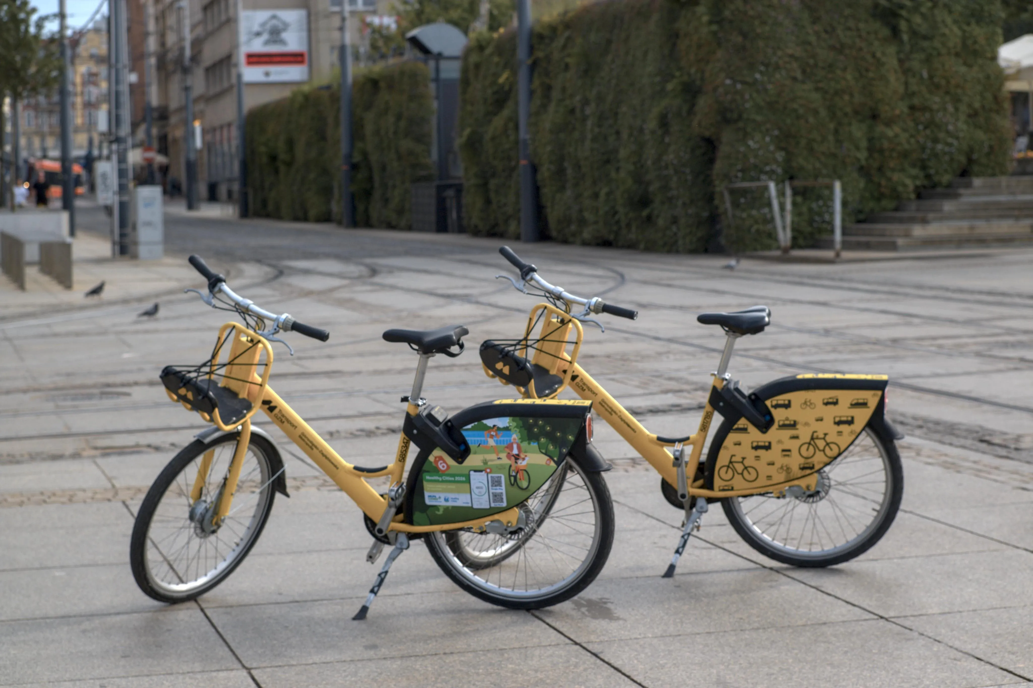 A photo of two yellow city bikes