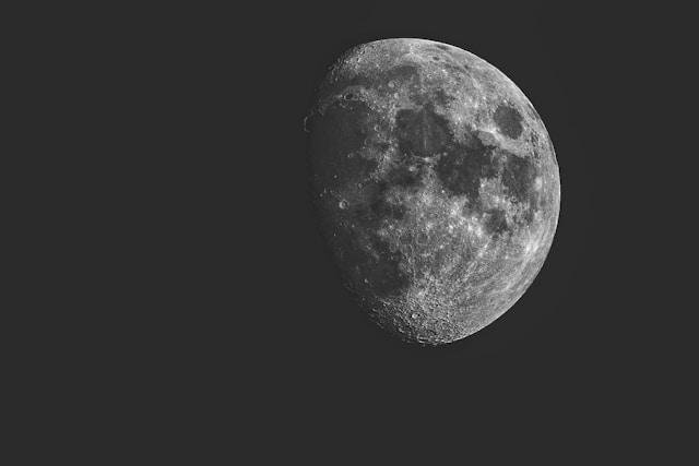 Black sky along with a grey moon 