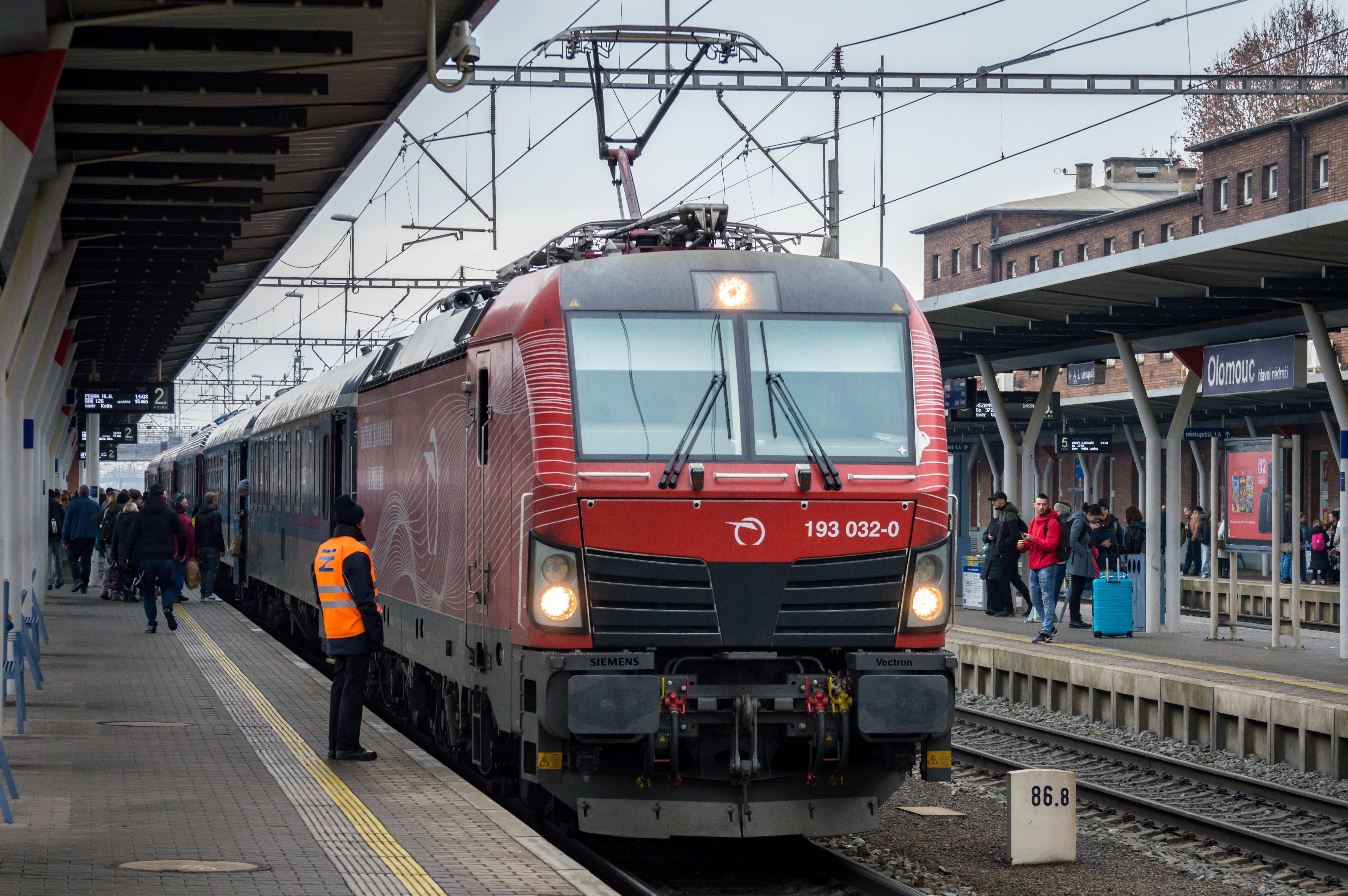 Správa železnic worker in a hi-vis vest waiting next to a locomotive to speak with a train driver at Olomouc hl.n., Czechia