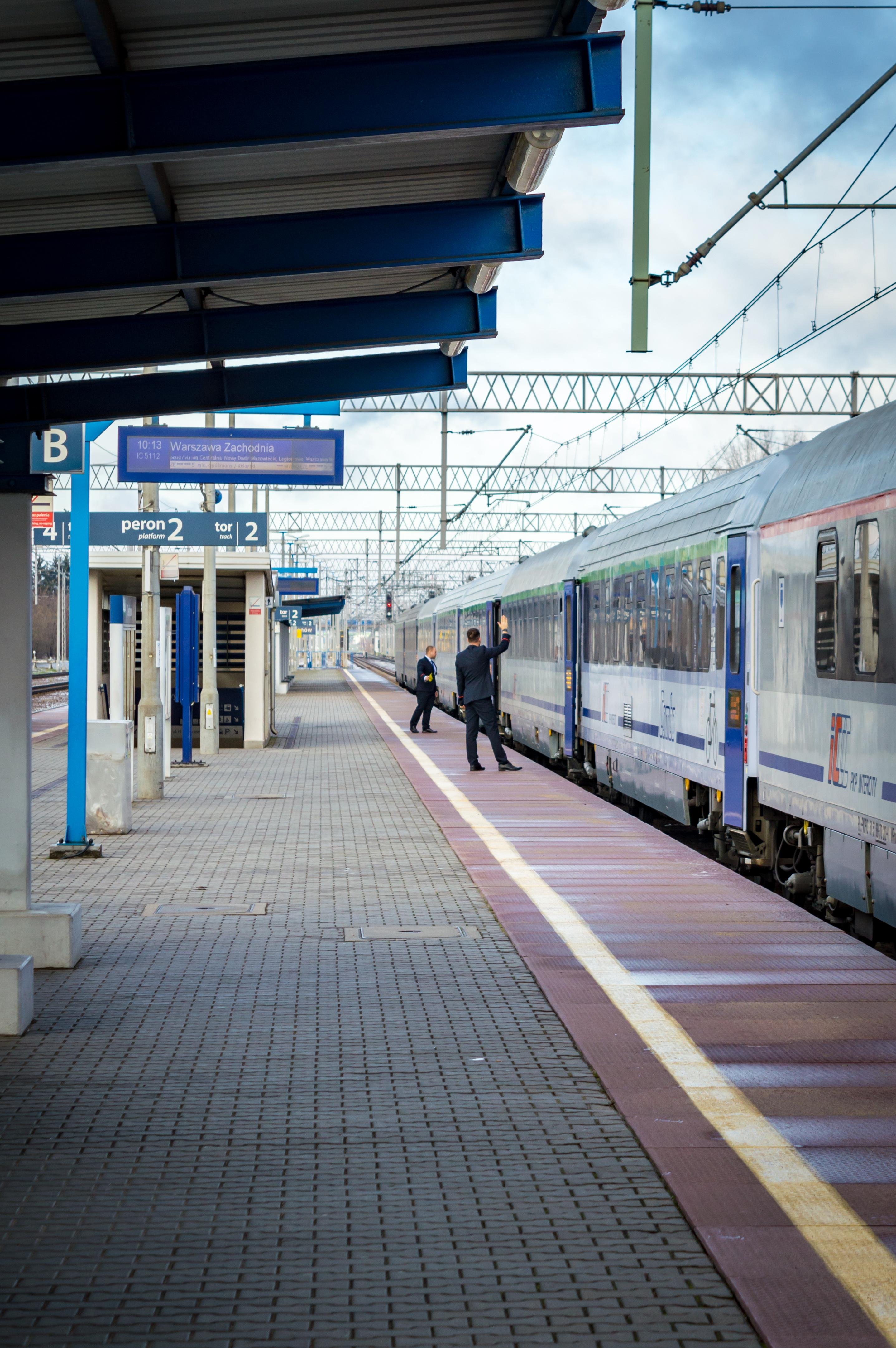 PKP IC train crew giving a signal for departure from the station