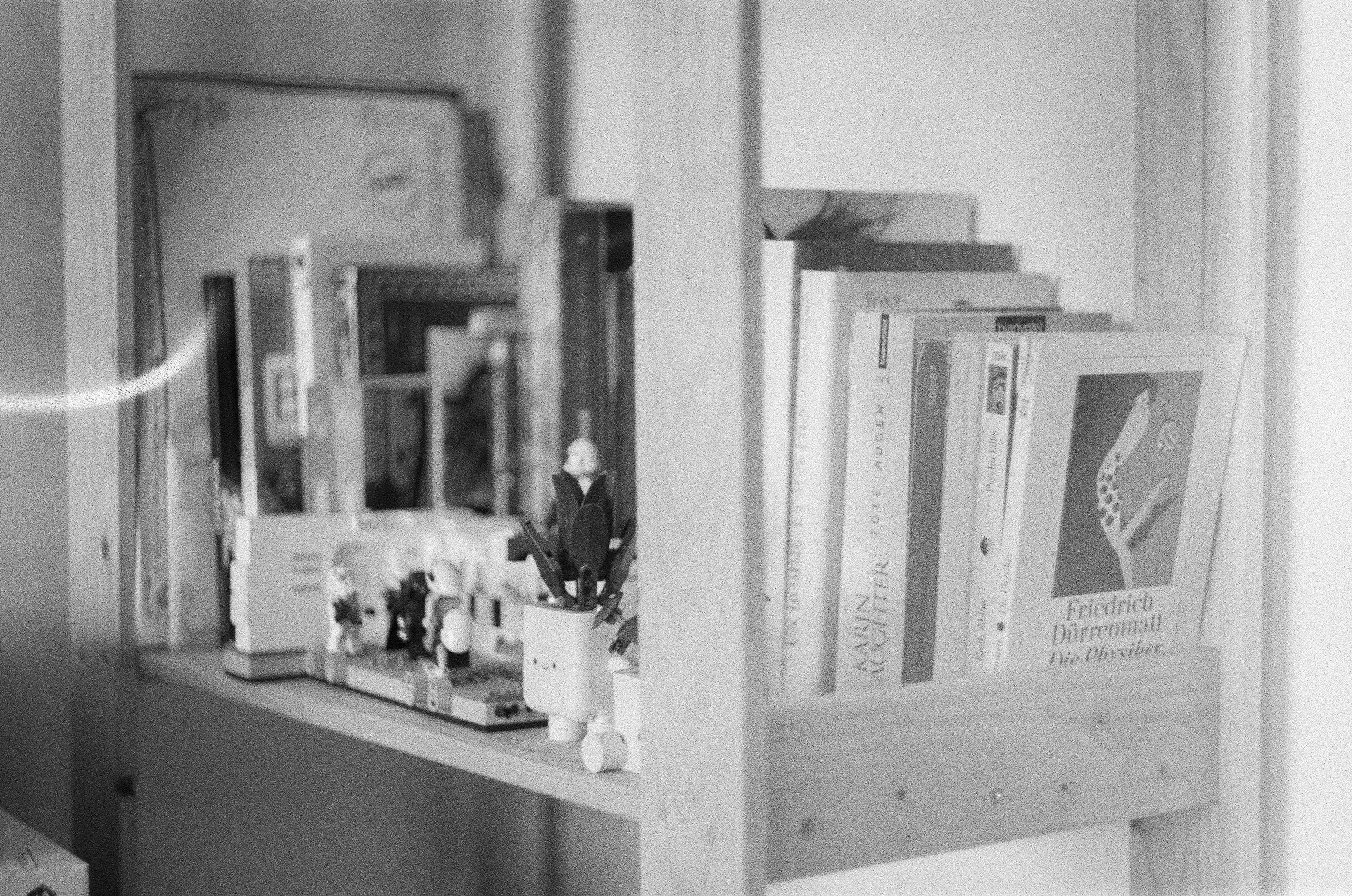 Toys and books on a wooden shelf