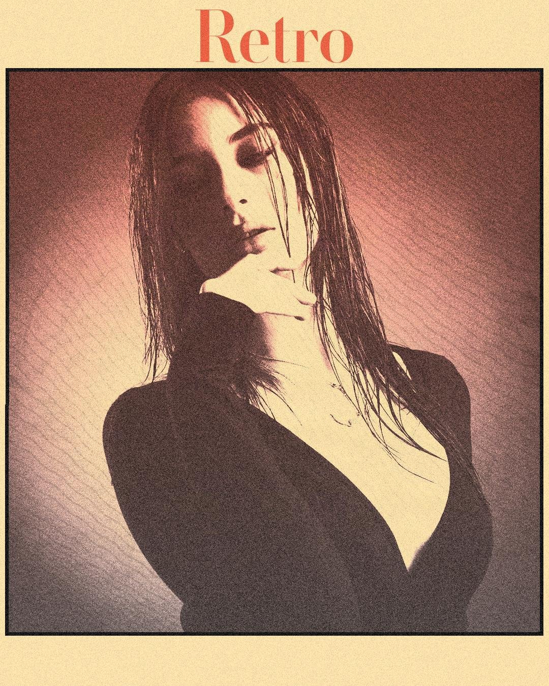 A woman with wet hair poses with a hand under her chin, looking down. She wears a low-cut black top. The image has a sepia-toned, vintage effect with a grainy texture, bordered by a thick black line. The word "Retro" in bold orange font is at the top against a pale background.