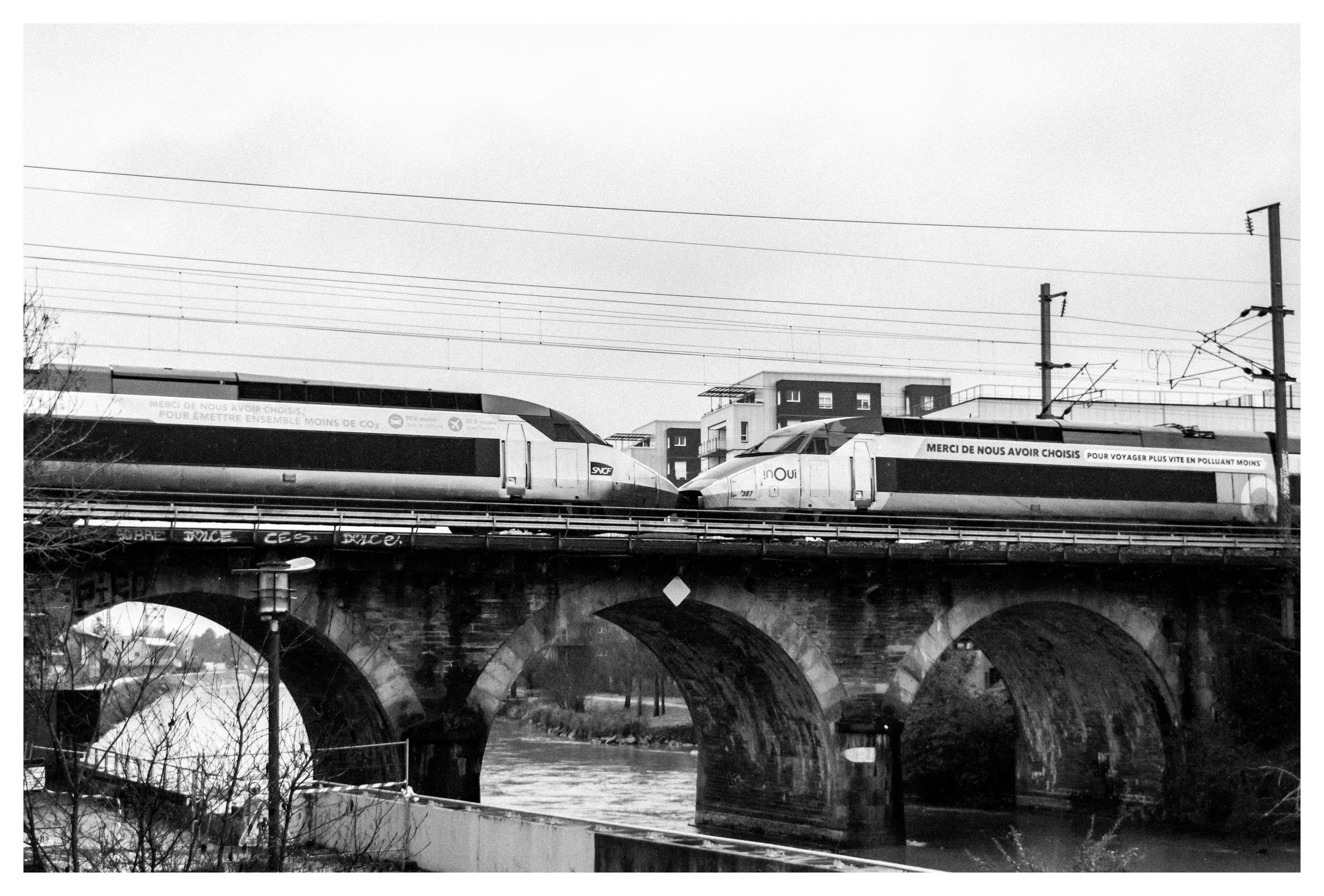 two coupled tgv atlantique trains passing through a bridge