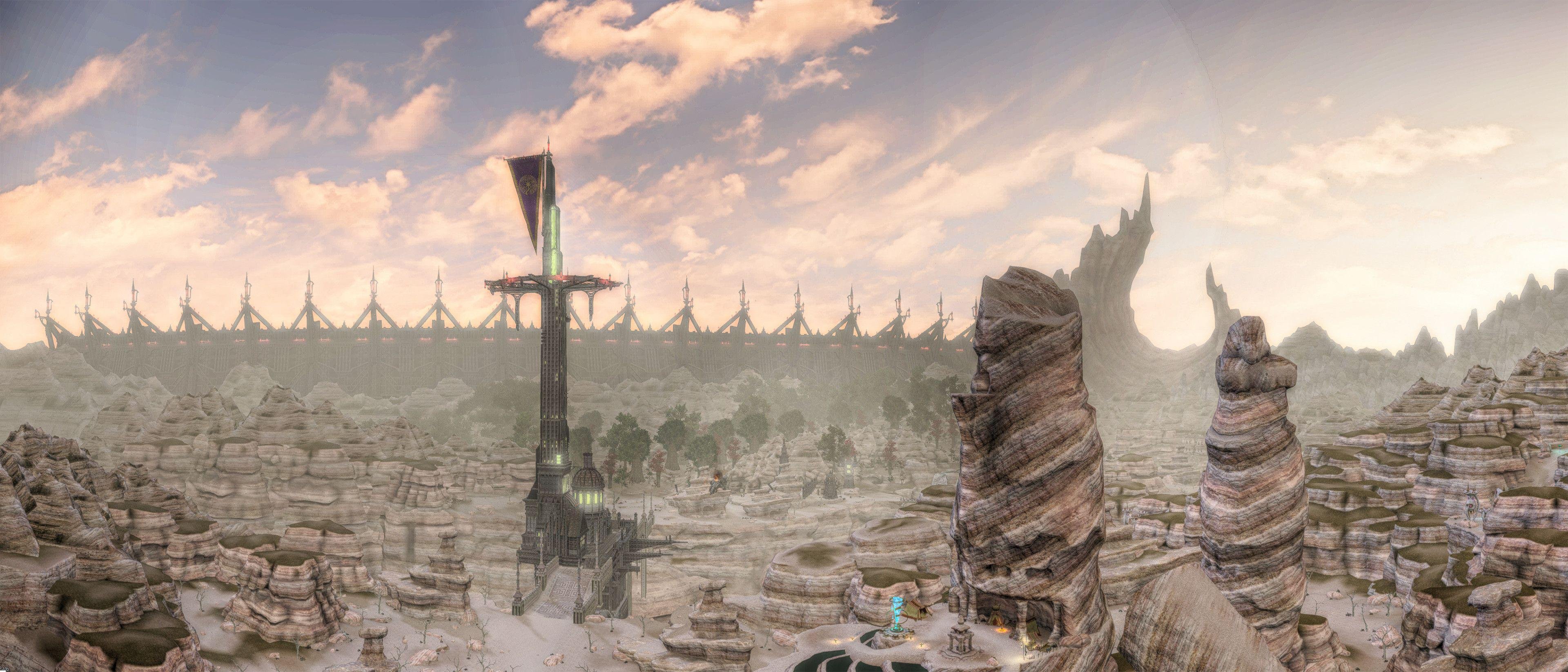 This image appears to be a digital rendering or concept art of a desert landscape. It features a large, central tower with a distinctive structure, set in a rocky, arid environment. There is a fence or wall with pointed extensions in the background. The sky is partly cloudy, giving the impression of a dramatic, expansive scene.