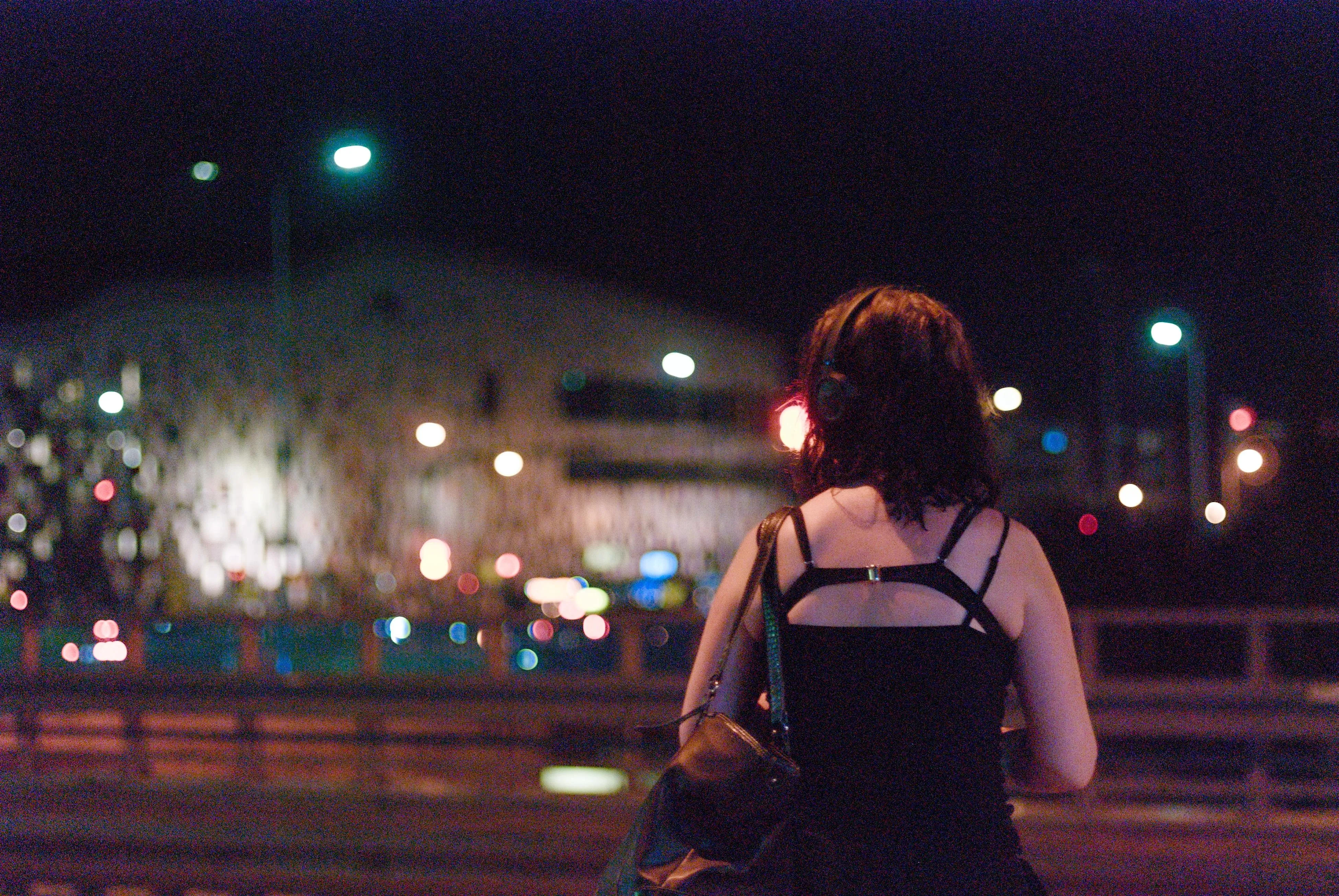 A photo of a person standing and waiting for a bus