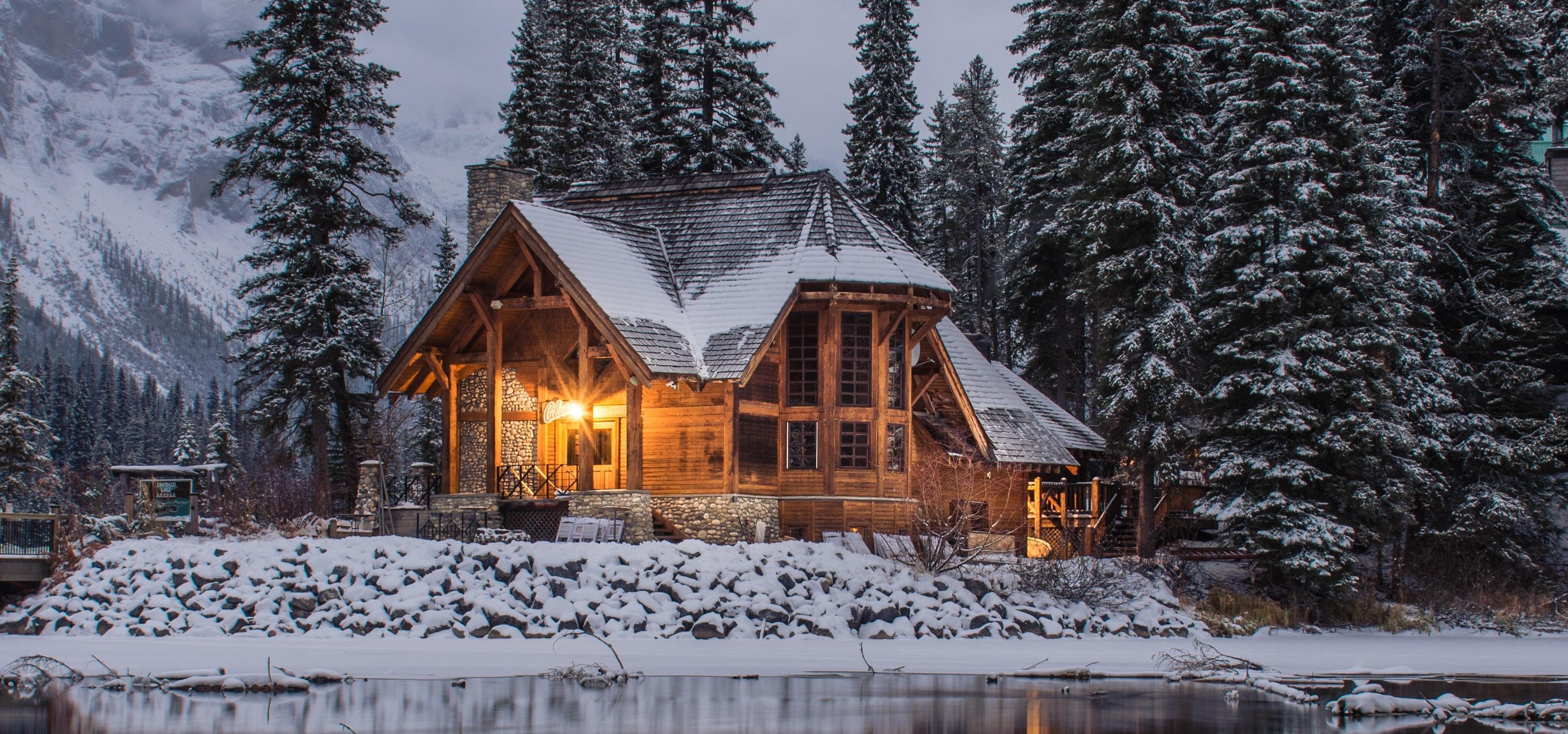 A winter scene with a snow bound wooden cabin