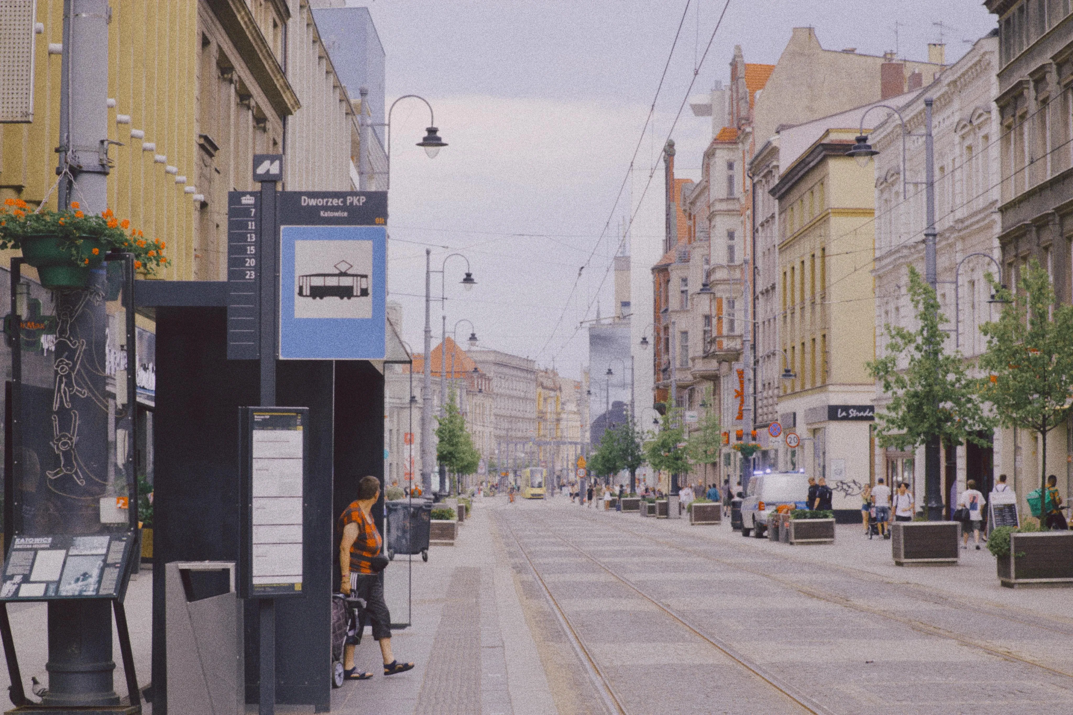 A photo of a tram stop and street with tracks