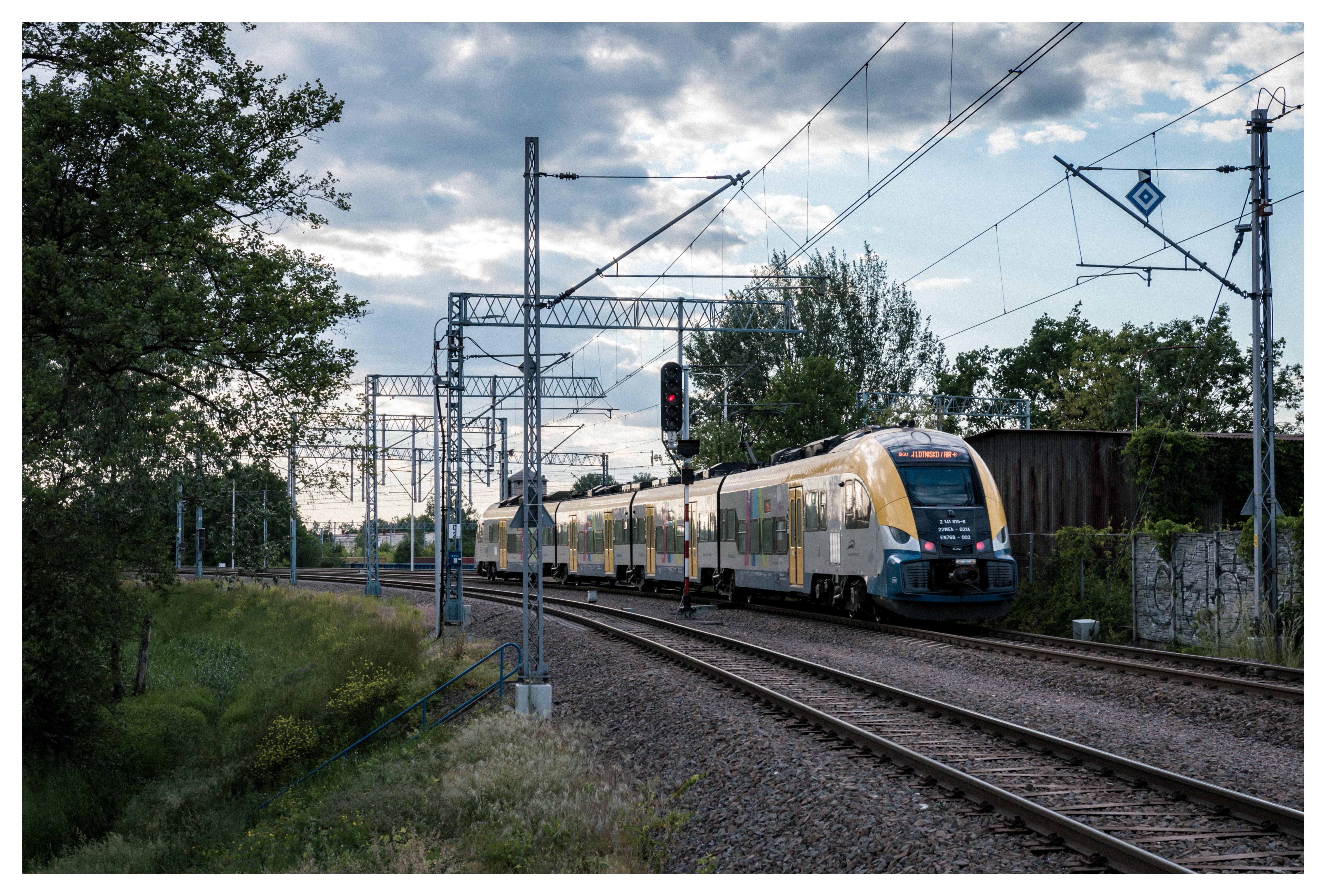 Koleje Małopolskie train after departing from a small passenger stop