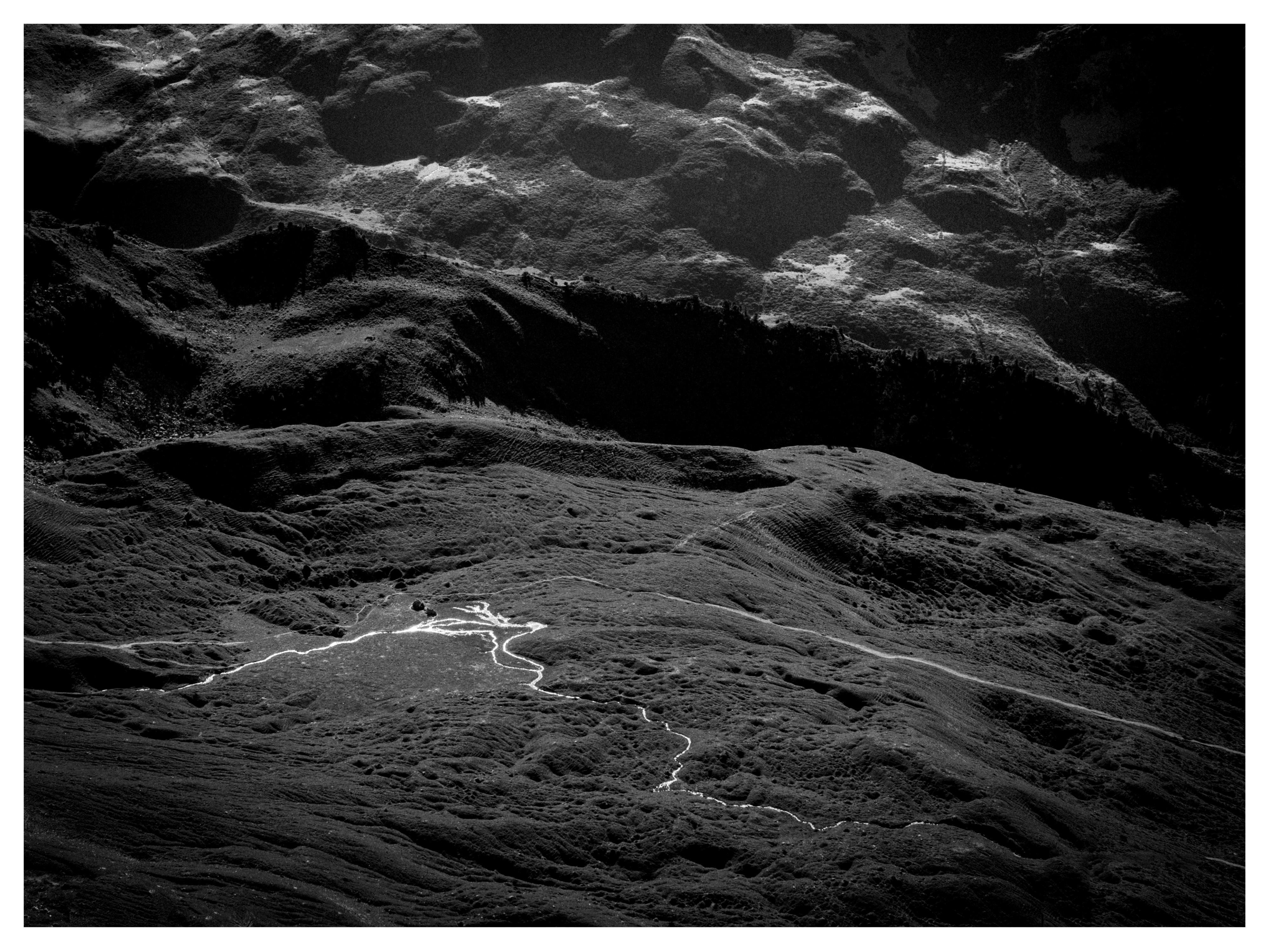 black and white mountains
a river winds through the hill
shadows fill the sky
h a.i. ku
