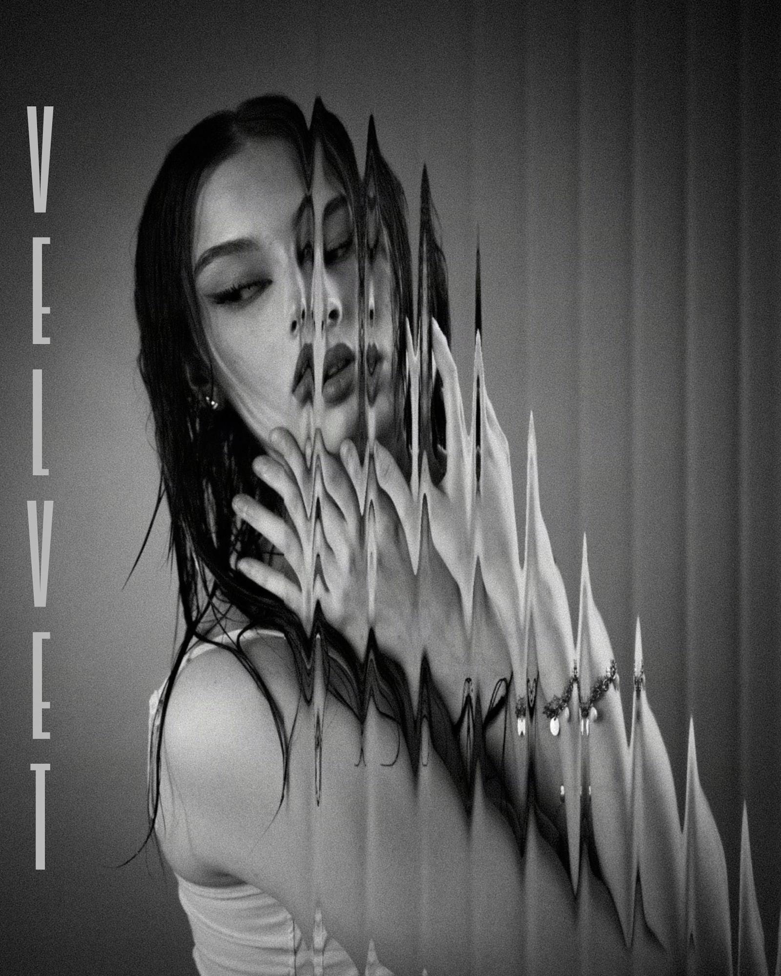 Black and white image of a woman with long hair, wearing a sleeveless top, partially obscured by a distorted, reflective surface. Her eyes are closed with visible eyeliner. Her hands are pressed against the surface which creates a wavy, mirrored effect, repeating her image. The word "VELVET" is vertically aligned on the left side.