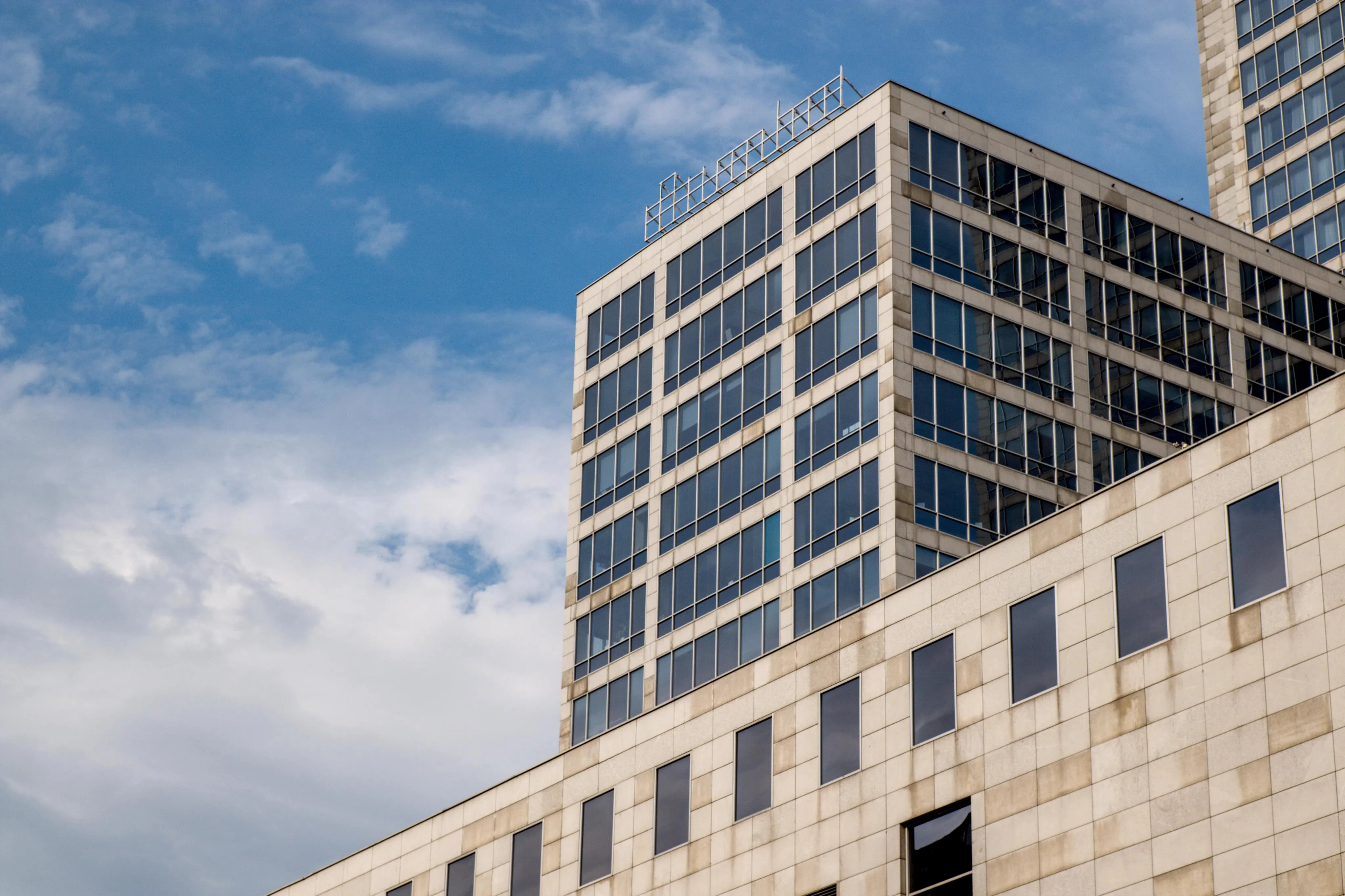 A photo of three sky scrapping buildings and sky
