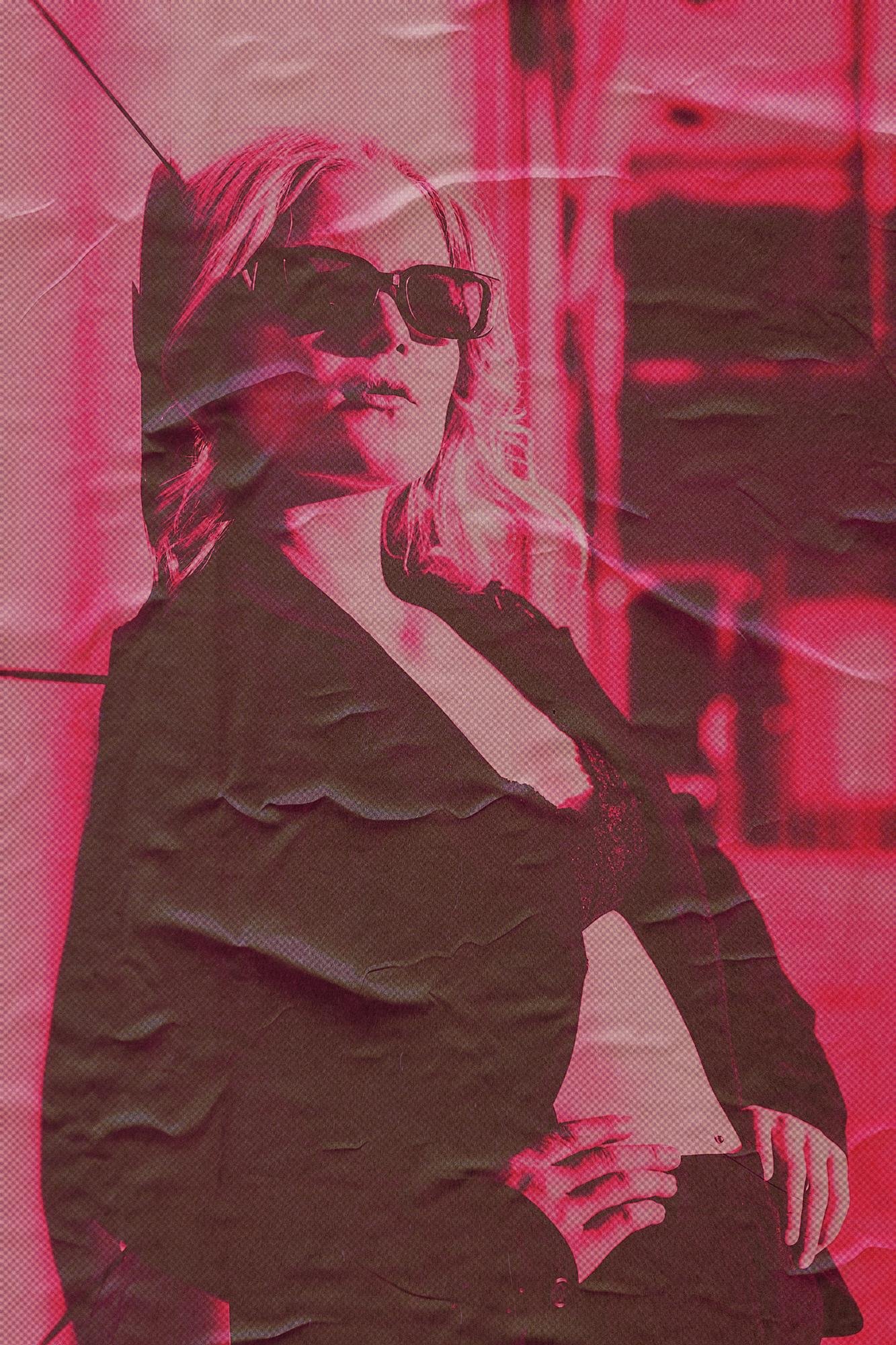 A woman with light hair wearing dark sunglasses and a blazer stands in a relaxed pose against a textured, pink-toned background. The image has a posterized effect with visible creases and folds, giving it a vintage, distressed look.